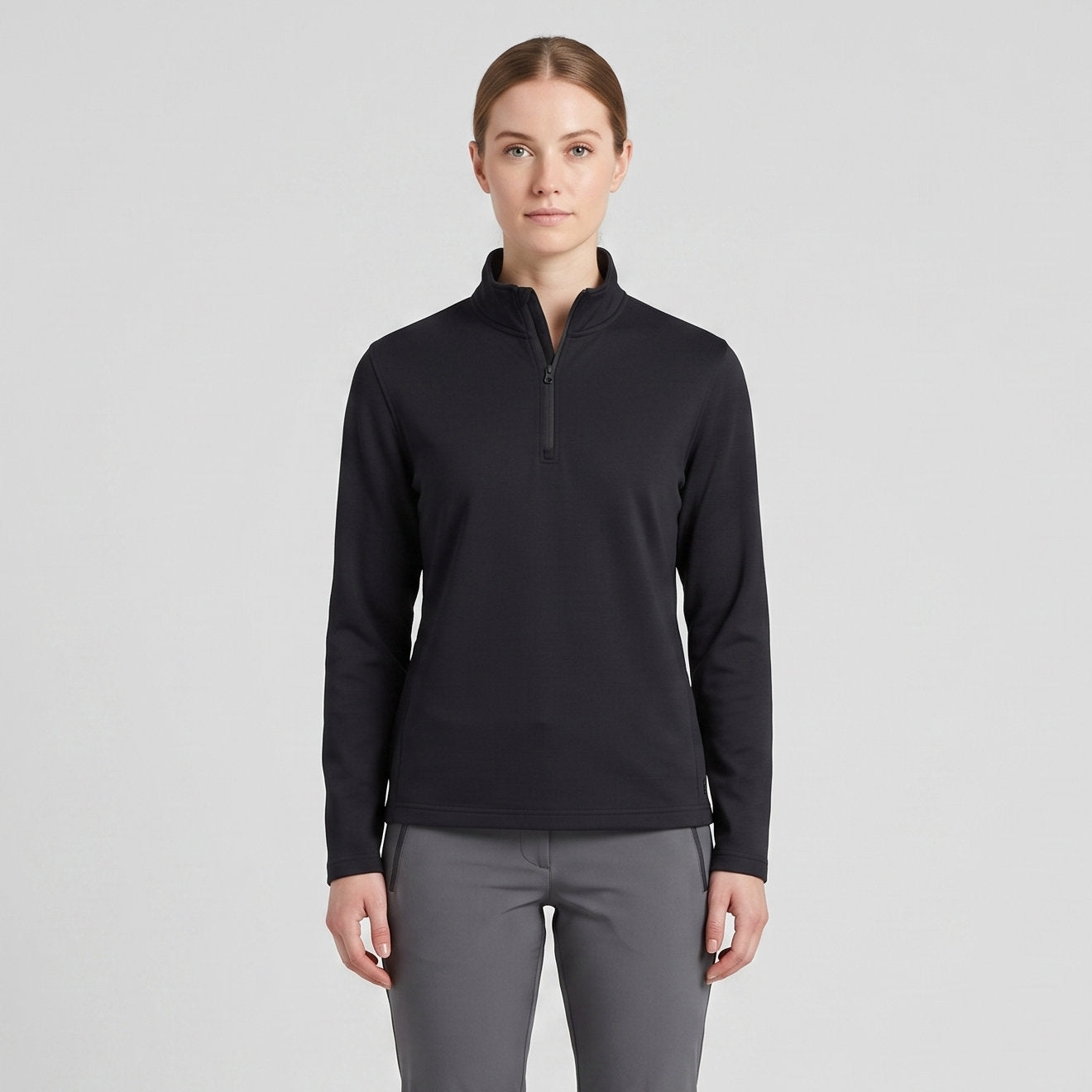 Female model wearing Obsidian Black All-Season Q-Zip Pullover, minimalist blank apparel for custom branding