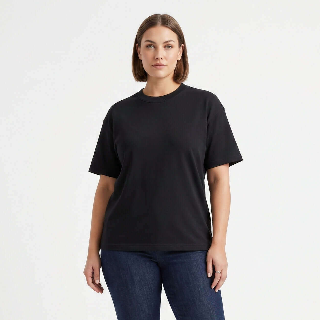 Female model wearing Obsidian Black premium blank t-shirt, 260 GSM heavyweight cotton with tear-away neck label for private labeling