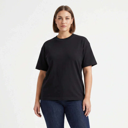 Female model wearing Obsidian Black premium blank t-shirt, 260 GSM heavyweight cotton with tear-away neck label for private labeling